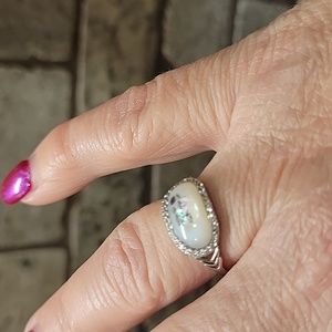 Mother of pearl oval ring with CZ halo. NWOT, never worn. 3 flowers on top.